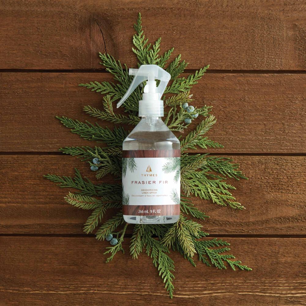 Thymes Frasier Fir Deodorizing Linen Spray Surrounded by Pine Stems image number 3